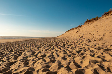 Sandy beach with blue sky taken from a low position