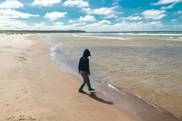 Small child on beautiful sandy beach Yyteri at summer, in Pori, Finland