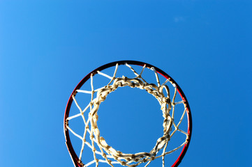 basketball net and hoop outdoors of sunny day against the blue sky, bottom view