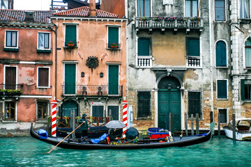 Gondolier on gondola on the Grand Canal in Venice, Italy. April 2012  Rainy day
