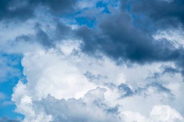 Cumulonimbus  clouds on a summer blue sky. Time before a thunderstorm. Abstract background