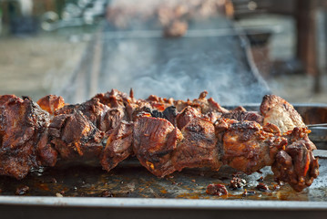 Barbecue fries in the coals. Meat and beef at the field kitchen festival.