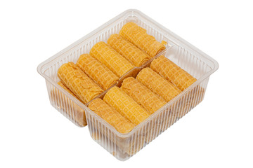 Wafer tubes with cream in a plastic container isolated on a white background