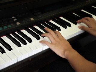 Fototapeta na wymiar Hands playing music on the piano
