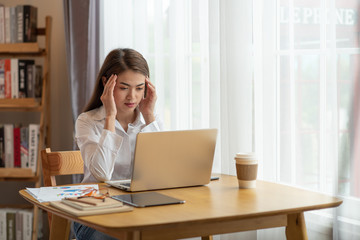 Stressed business woman with palm on face in her office