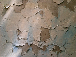 The wall of the house, covered with old paint.