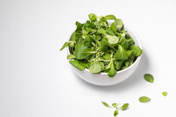 Fresh green salad isolated on white background, flat lay.