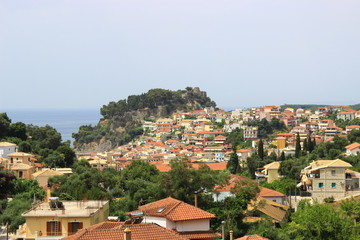 Fototapeta na wymiar Panoramic view from a hill of the traditional Greek village of Parga and the venetian castle. Background view of blue sea and sky