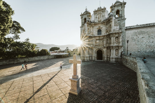 Almost empty courtyard of basilica in oaxaca city mexico at sunset