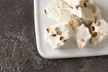 Italian festive torrone. Nougat with almonds. Breakfast