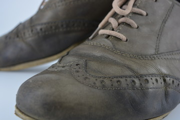 Women's unusual gray brown shoes, shoes from genuine leather in the English style. Aristocratic and antique shoes with worn leather and special colors are located on a white background.