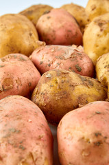 Fresh red and white potatoes isolated on white background. Background of organic food.