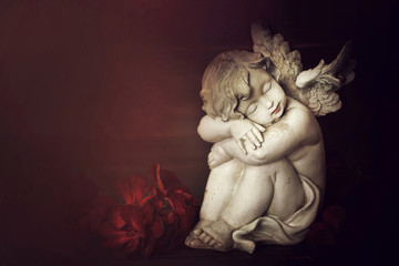 Guardian angel and flowers on dark background with copy space