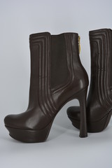 Brown women's stylish autumn boots made of genuine leather with high and thin heels.