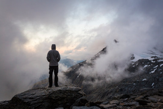 Figure overlooking a cloud covered mountain view in New Zealand