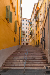 Fototapeta na wymiar Typical district in Nice, with a staircase and colorful façades