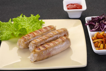 Grilled sausages served mushrooms and cabbage
