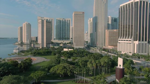 Aerial over Downtown Miami, Bayfront Park, morning traffic & waterfront at sunrise. Florida, USA. 9 July 2019