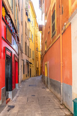 Typical district in Nice, with a narrow street and colorful facades