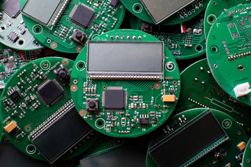 round electronic boards with display, microchip and processor, many clock components, close-up