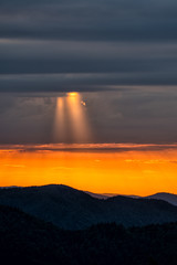 A wonderful sunset in the mountains. Orange sky and dark silhouettes of mountains. Carpathian Mountains landscape. Bieszczady. Poland