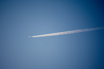 Airplane in the sky with a trail