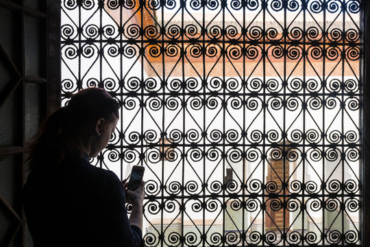 Woman standing on a window in Marocco, moorish archtecture, female 33
