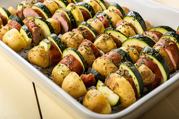 Potato skewers with sausage and zucchini