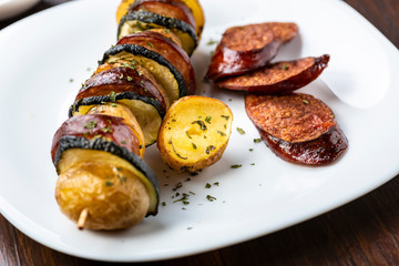 Potato skewers with sausage and zucchini