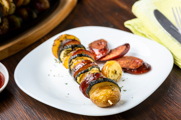 Potato skewers with sausage and zucchini