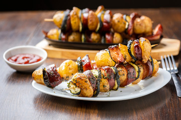 Potato skewers with sausage and zucchini