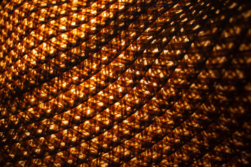 pattern of old straw hat with illuminating from beneath into her