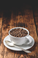 Roasted coffee beans in white cup