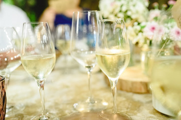 Several glasses with bubbly and fresh champagne served on the table of a banquet.