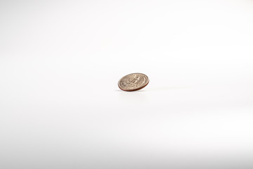 Dollar coin rotating on white background, concept of American economy.