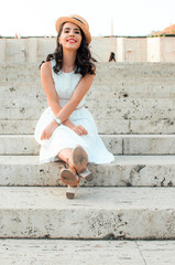 candid woman in white dress sitting,street style