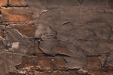 Detailed old brick wall background texture. Surface covered with sloppy cement smears. Vintage interior.