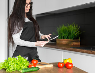 Young trendy woman cooking healthy food in the morning