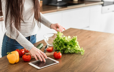 Young trendy woman cooking healthy food in the morning