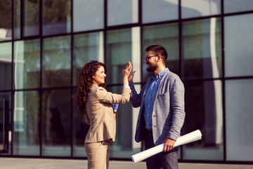 Business people showing team work and giving high five