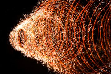 Spiral of fire that explodes in numerous sparks