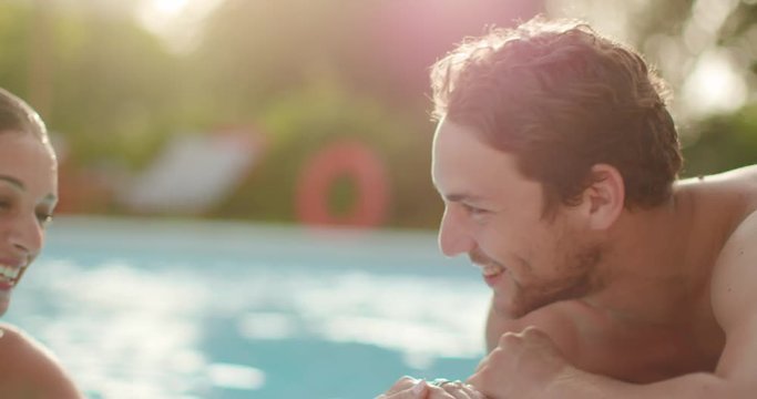 Woman and man smiling near swimming pool water.Beautiful romantic couple relaxing and sunbathing at luxury rural villa house. Friends italian trip in Umbria.4k slow motion