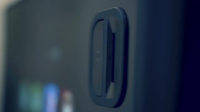 Inserting coin into a vending machine and pressing return coin button