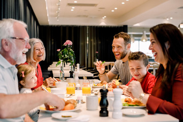 Multigenerational family having food in restaurant