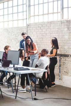Team of happy computer hackers working together in creative office