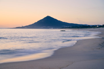 Sunset at the Moledo beach, with a mountain on backgroud