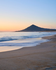 Fototapeta na wymiar Sunset at the Moledo beach, with a mountain on backgroud