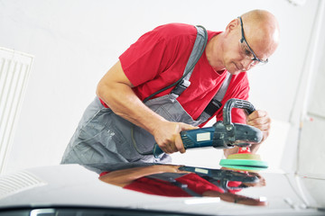 auto mechanic buffing car autobody