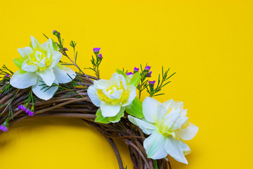 wreath decorated with daffodils on a yellow background