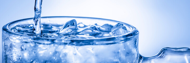 Banner Of Cold Clear Water Pouring Into Glass Over Crushed Ice